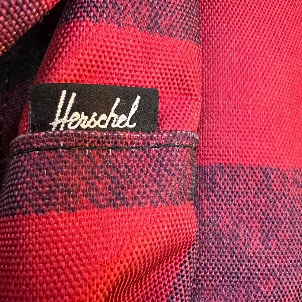 Herschel Supply Co. Pop Quiz backpack in a red and black buffalo plaid pattern.